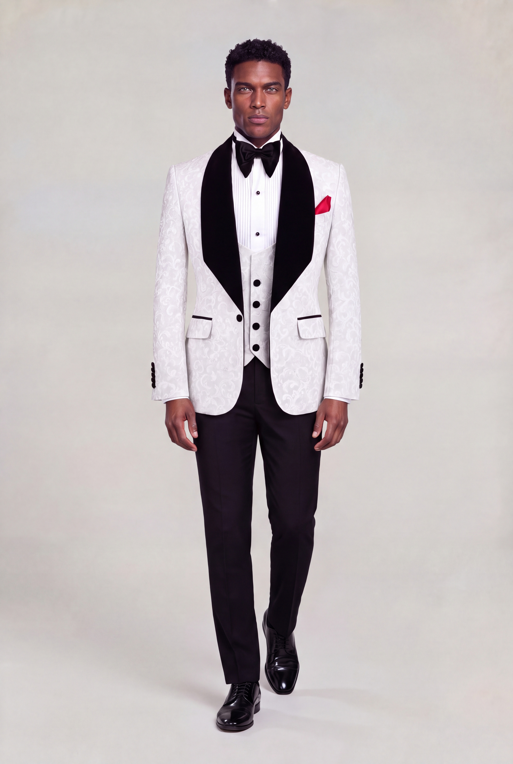 Front walking pose in a white damask tuxedo with solid black trousers and black dress shoes from Gentleman's Guru