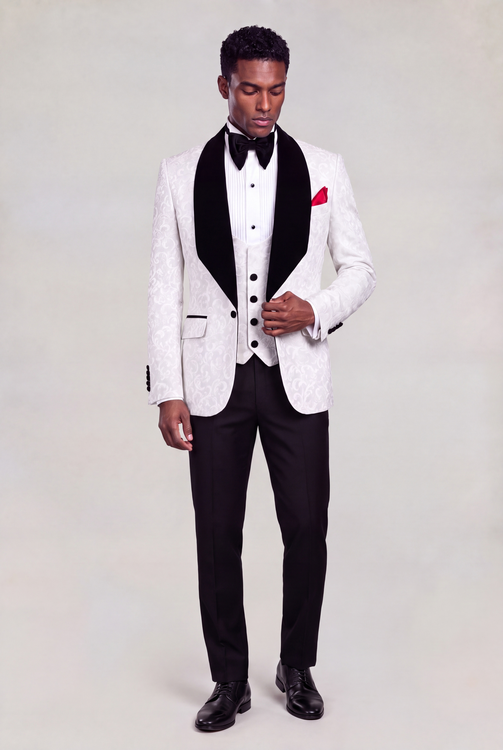Full-body standing pose styling a white damask jacket with black velvet lapels and matching vest from Gentleman's Guru