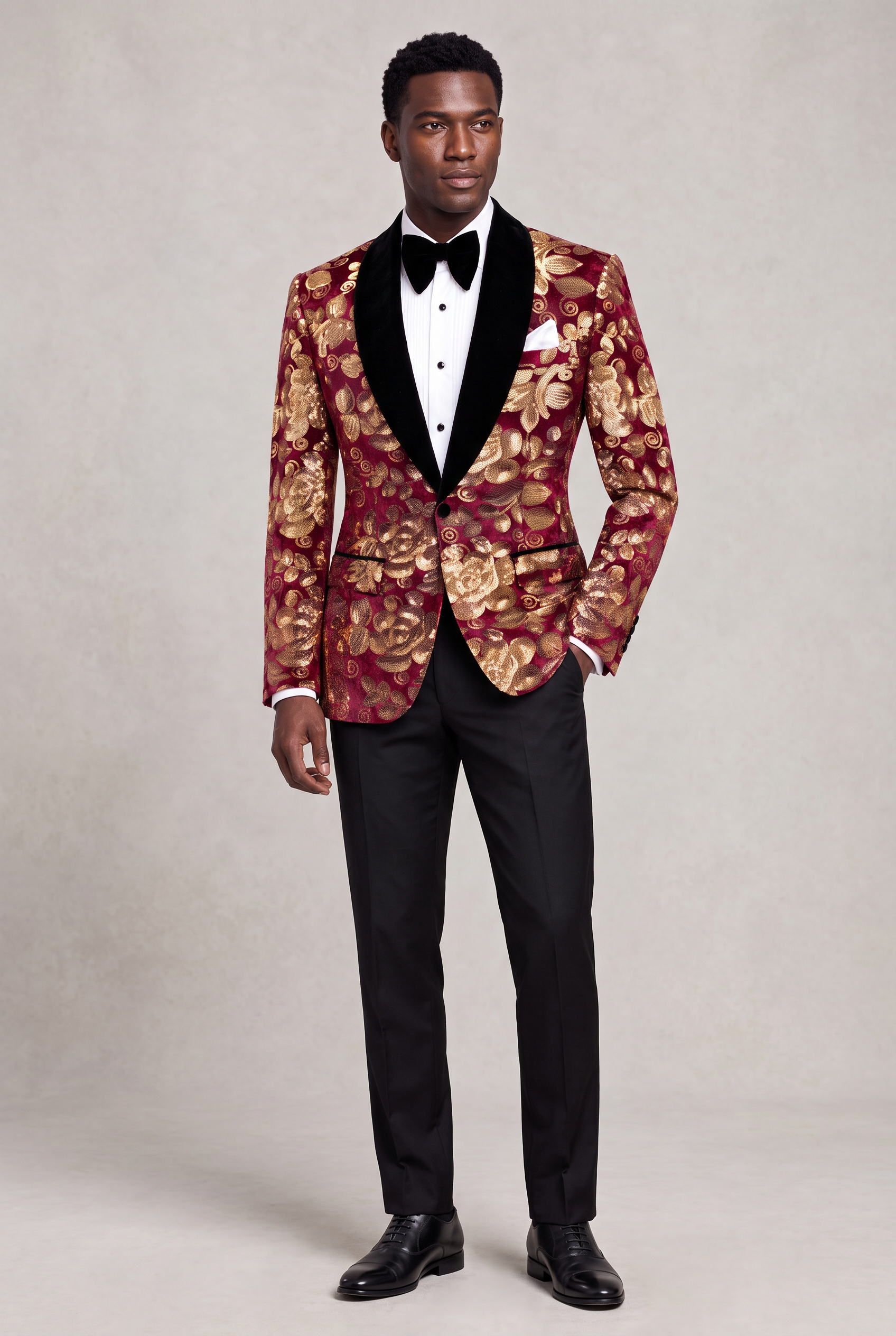 Burgundy and Gold Velvet Tuxedo Jacket full body angled standing with black bow tie and trousers from Gentlemansguru.com