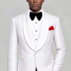 White floral shawl-lapel tuxedo jacket paired with solid black trousers and a red pocket square from Gentleman's Guru