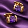 Amethyst and gold wedding cufflinks arranged on matching purple silk from Gentlemansguru.com