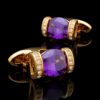 Luxury purple and gold cufflinks for men on a black reflective studio background from Gentlemansguru.com