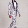 Full-body side walking view of a men’s white and black patterned three-piece suit with black dress shoes from Gentleman's Guru
