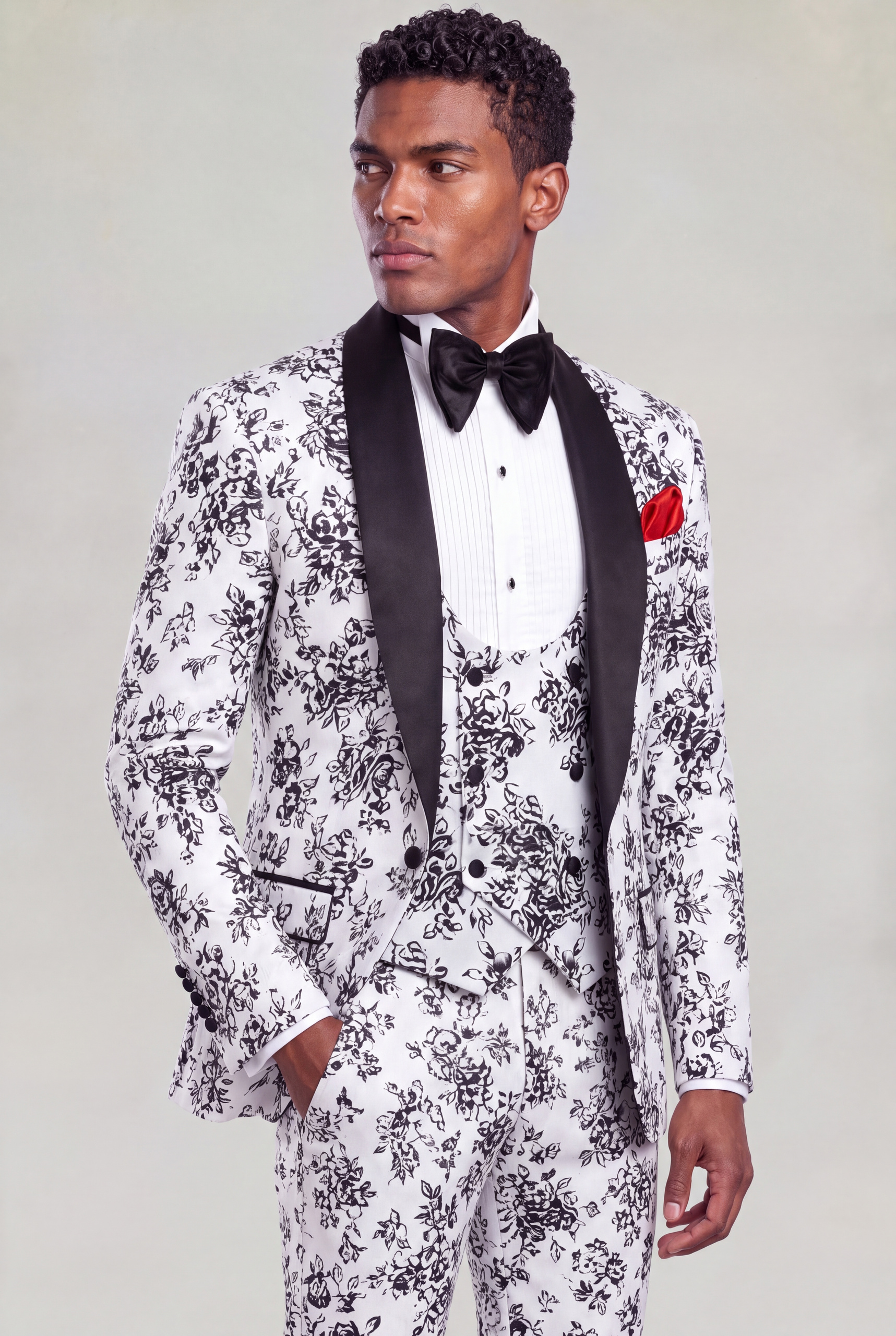 Side portrait of a white and black floral wedding suit with matching patterned trousers from Gentleman's Guru
