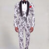 Full-length front walking view of a white and black floral prom tuxedo with matching trousers and black dress shoes from Gentleman's Guru