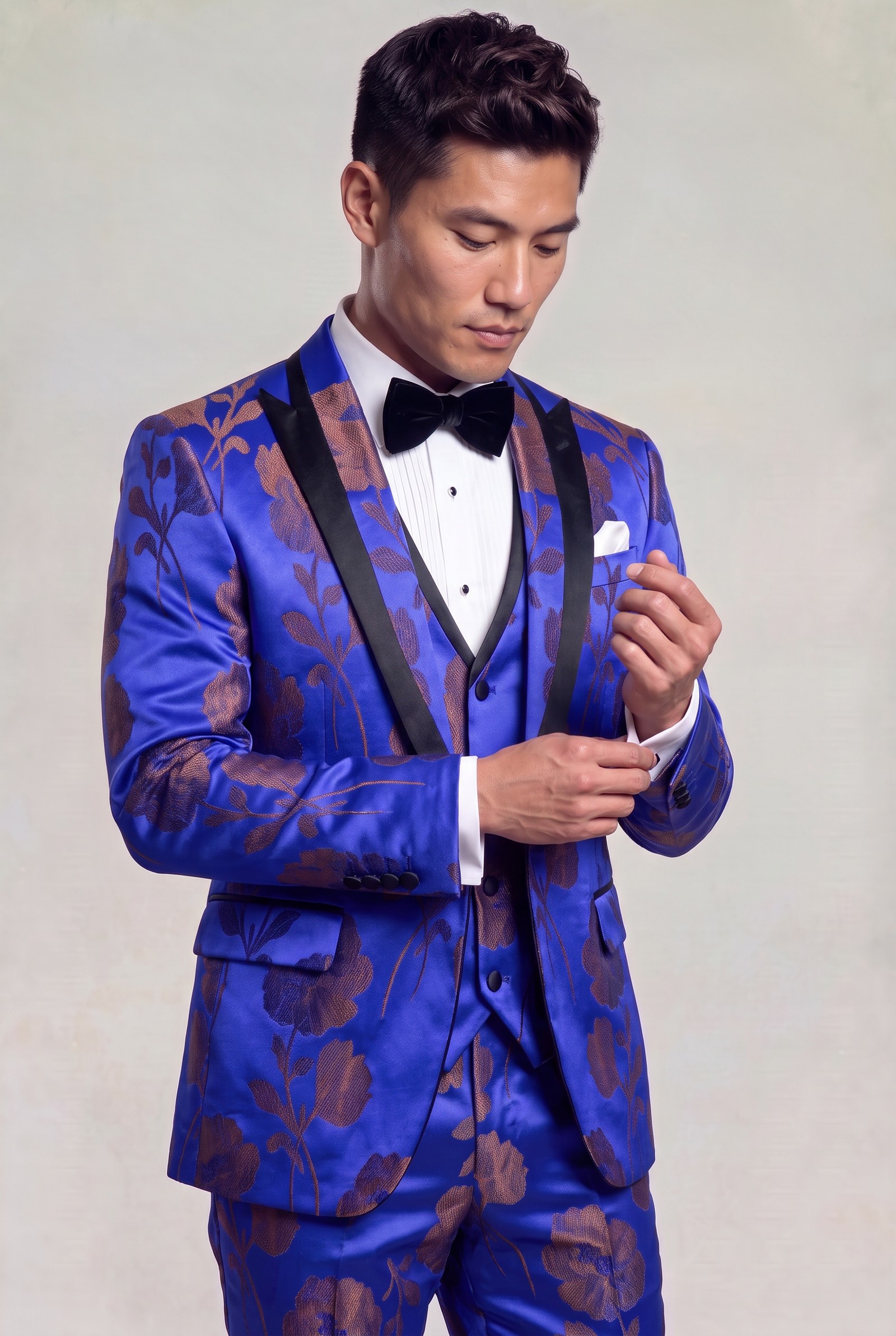 Royal blue and bronze floral tuxedo with model adjusting his shirt cuff
