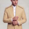Champagne beige mandarin collar jacket with gold cuff buttons in a cuff-adjusting pose