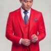 Bright red suit jacket and matching vest in a cuff-adjusting pose