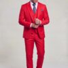Full-body red wedding suit in a cuff-adjusting pose