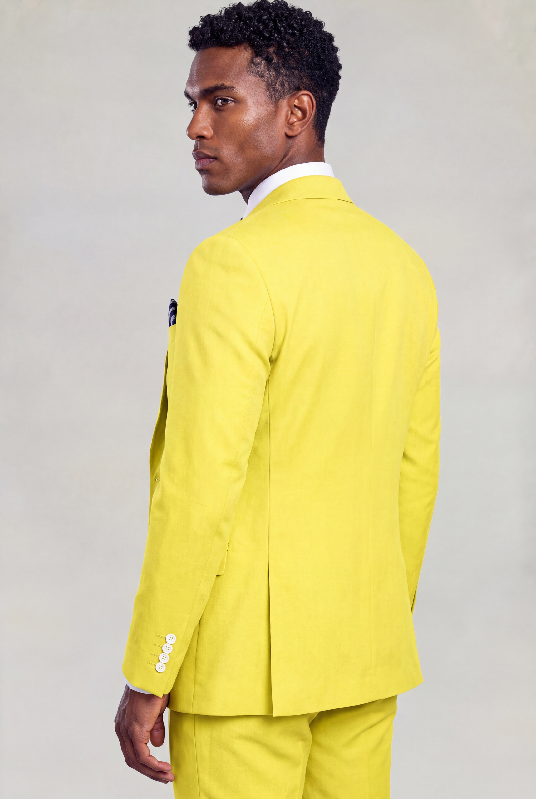Rear three-quarter view of a plain yellow suit jacket with matching trousers from Gentleman's Guru