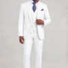 Full-body view of a model styling a white suit jacket over a matching four-button vest from Gentleman's Guru