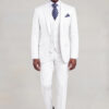 Front walking pose in a white three-piece suit with matching trousers and black dress shoes from Gentleman's Guru