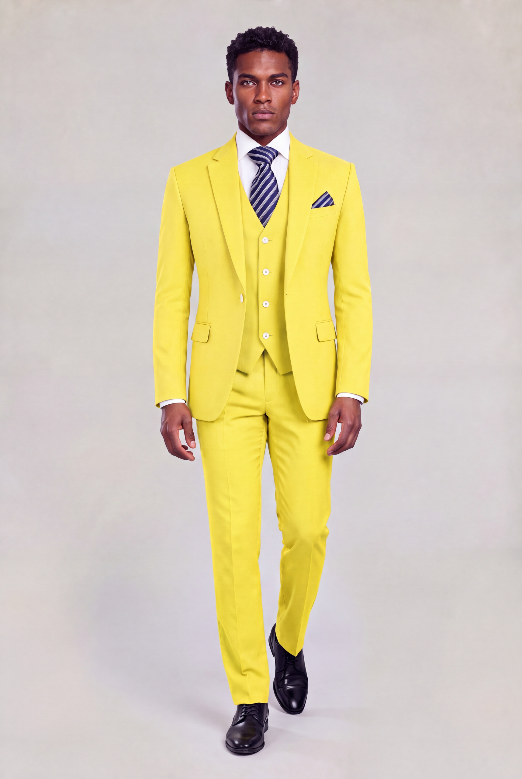 Front walking view of a yellow three-piece suit with a four-button vest and black dress shoes from Gentleman's Guru