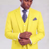 Model adjusting his cuff in a yellow wedding suit with a navy striped tie from Gentleman's Guru