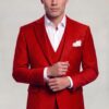 Red polka dot suit jacket in a cuff-adjusting pose