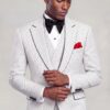 Model adjusting his cuff in a white polka dot three-piece suit with black piping from Gentleman's Guru