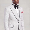 Three-quarter side portrait of a white polka dot suit with black-trimmed lapels and matching trousers from Gentleman's Guru