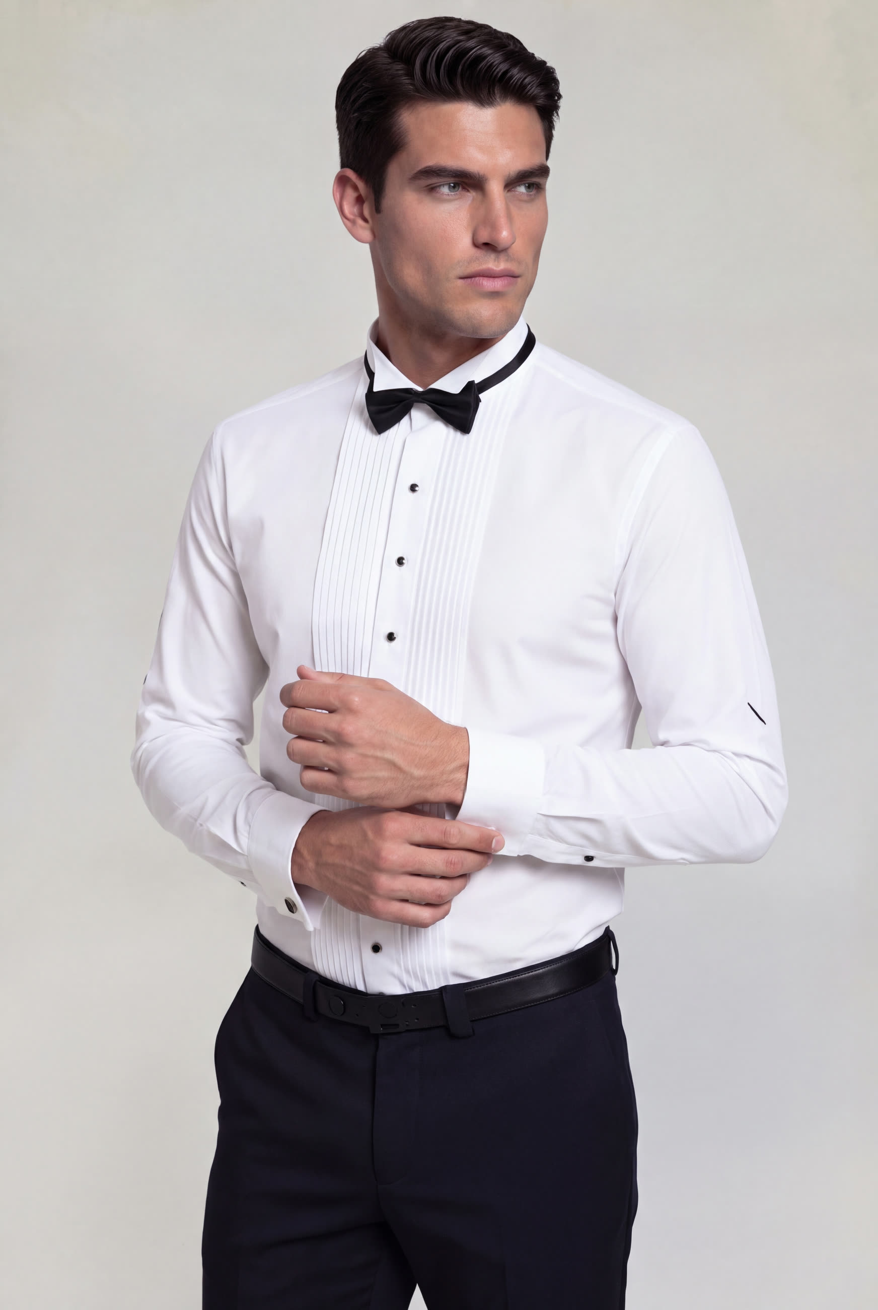 Men's white French cuff tuxedo shirt with black buttons and black bow tie for wedding and formal wear