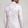 Three-quarter back view showing the rose gold abstract pattern and tailored shape of the ivory tuxedo jacket from Gentleman's Guru