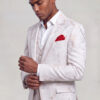 Model adjusting his cuff in an ivory and rose gold abstract-print three-piece suit from Gentleman's Guru
