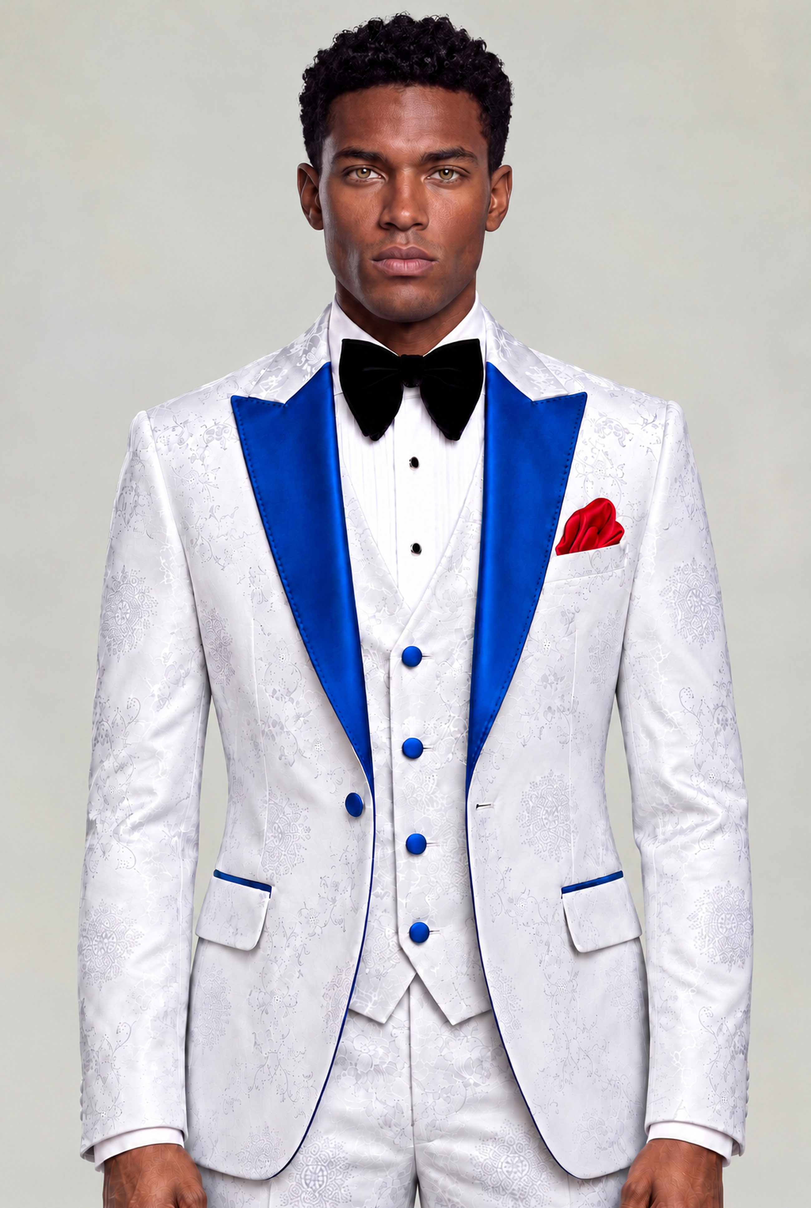 Front view of the white floral three-piece tuxedo with royal blue lapels and matching white trousers from Gentleman's Guru