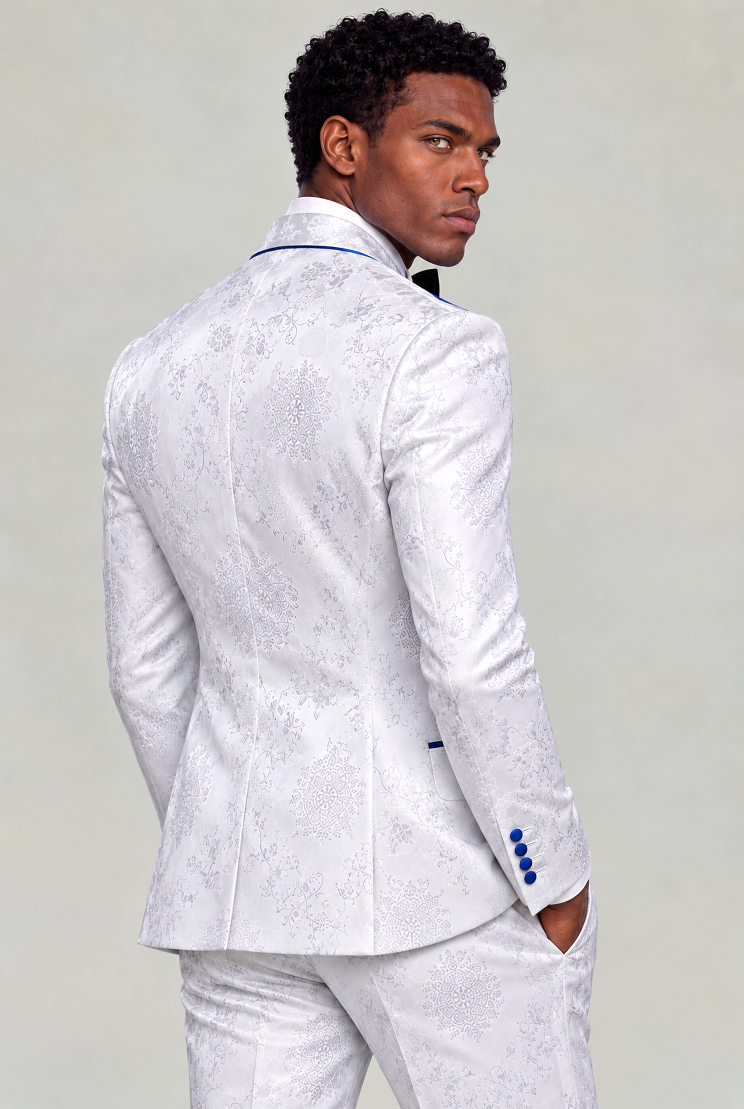 Back three-quarter view showing the white and silver floral jacket pattern with matching trousers from Gentleman's Guru