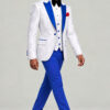Full-body walking pose looking off camera in a white floral evening jacket, blue trousers and black shoes from Gentleman's Guru