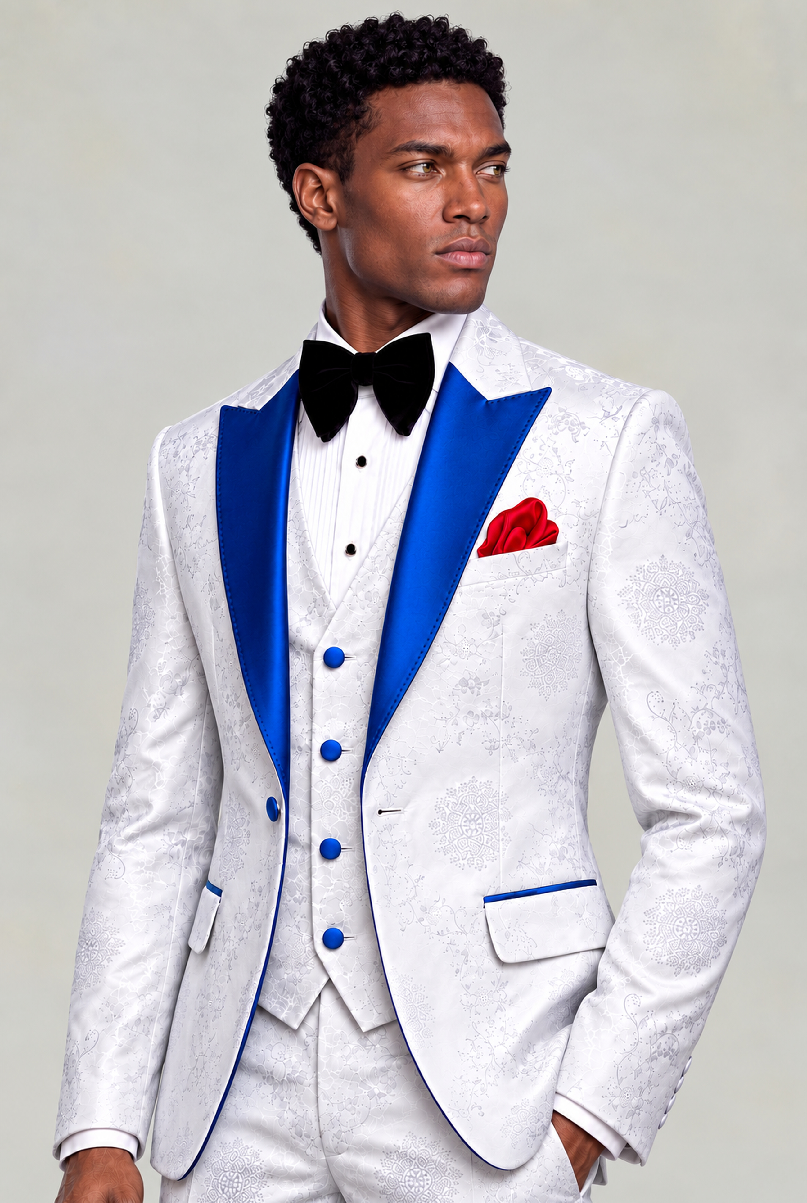 Three-quarter portrait showing royal blue satin lapels, white floral vest and red pocket square from Gentleman's Guru