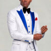 Model adjusting his cuff in a white floral wedding tuxedo with royal blue satin lapels from Gentleman's Guru