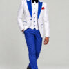 Full-length walking view of the white floral tuxedo with solid blue pants and black dress shoes from Gentleman's Guru