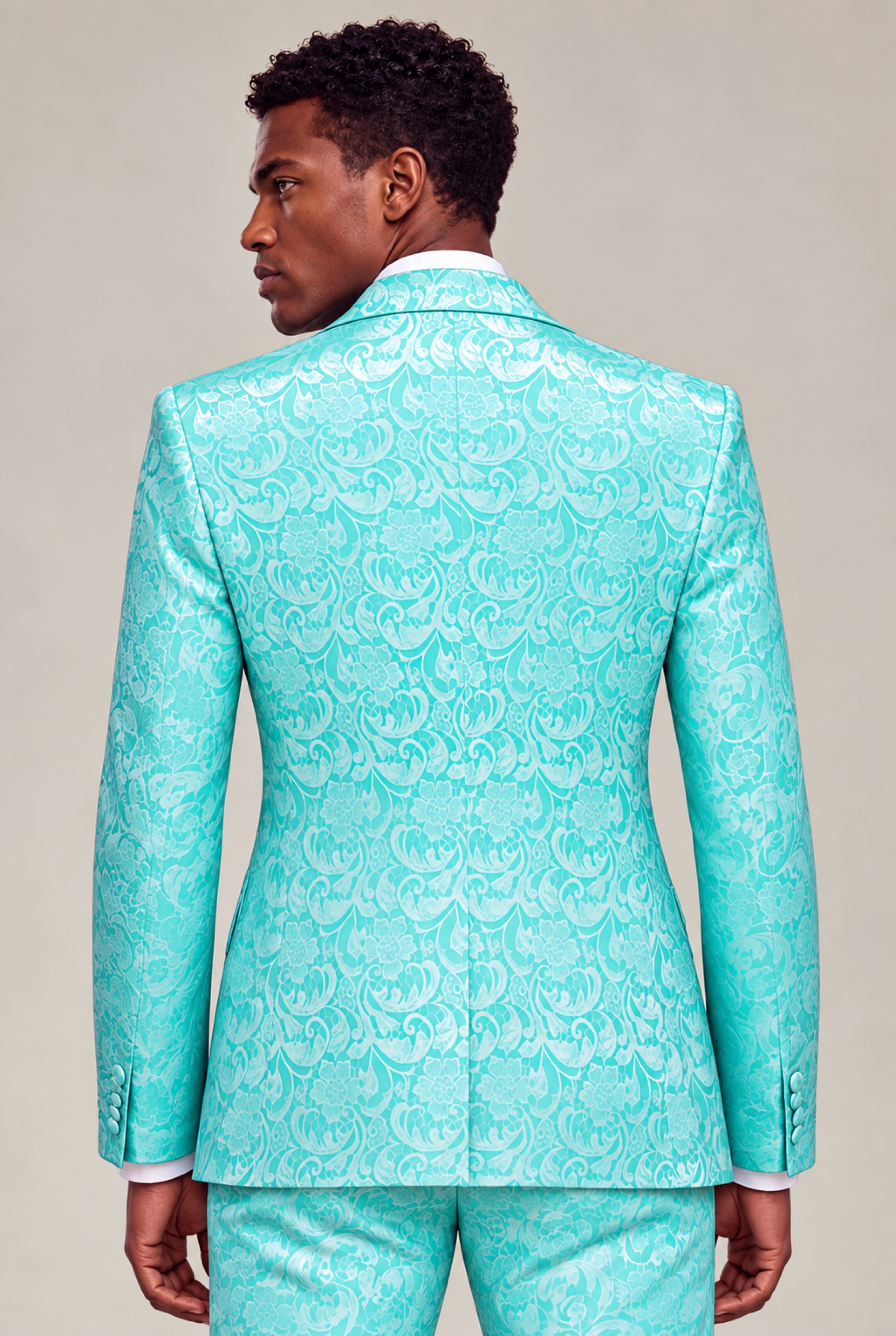 Rear view showing the floral pattern and fit of the turquoise suit jacket from Gentleman’s Guru