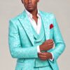 Model adjusting his cuff in a turquoise floral suit with matching vest from Gentleman’s Guru