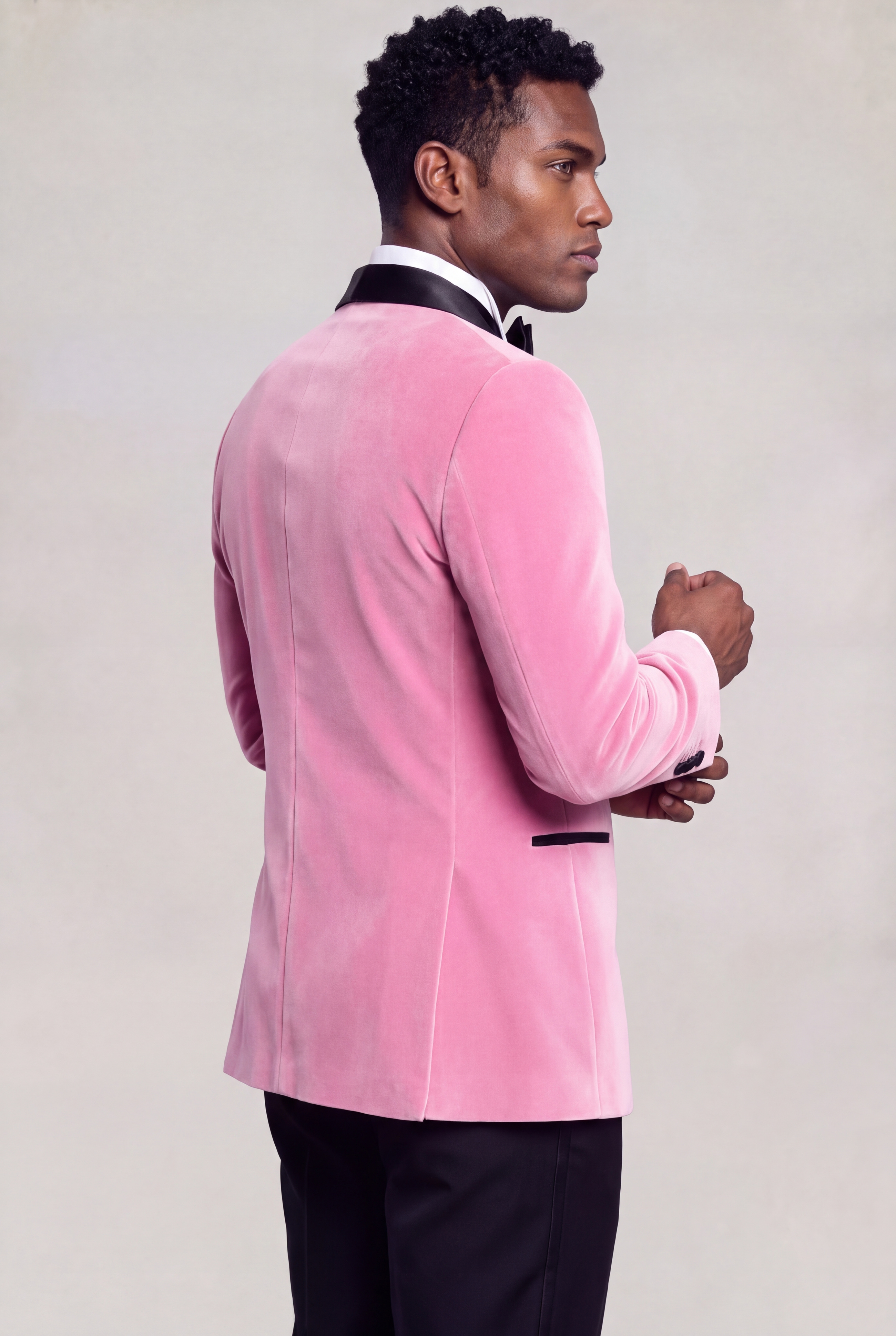 Back view of a men's light pink velvet tuxedo jacket on a model — Gentleman's Guru