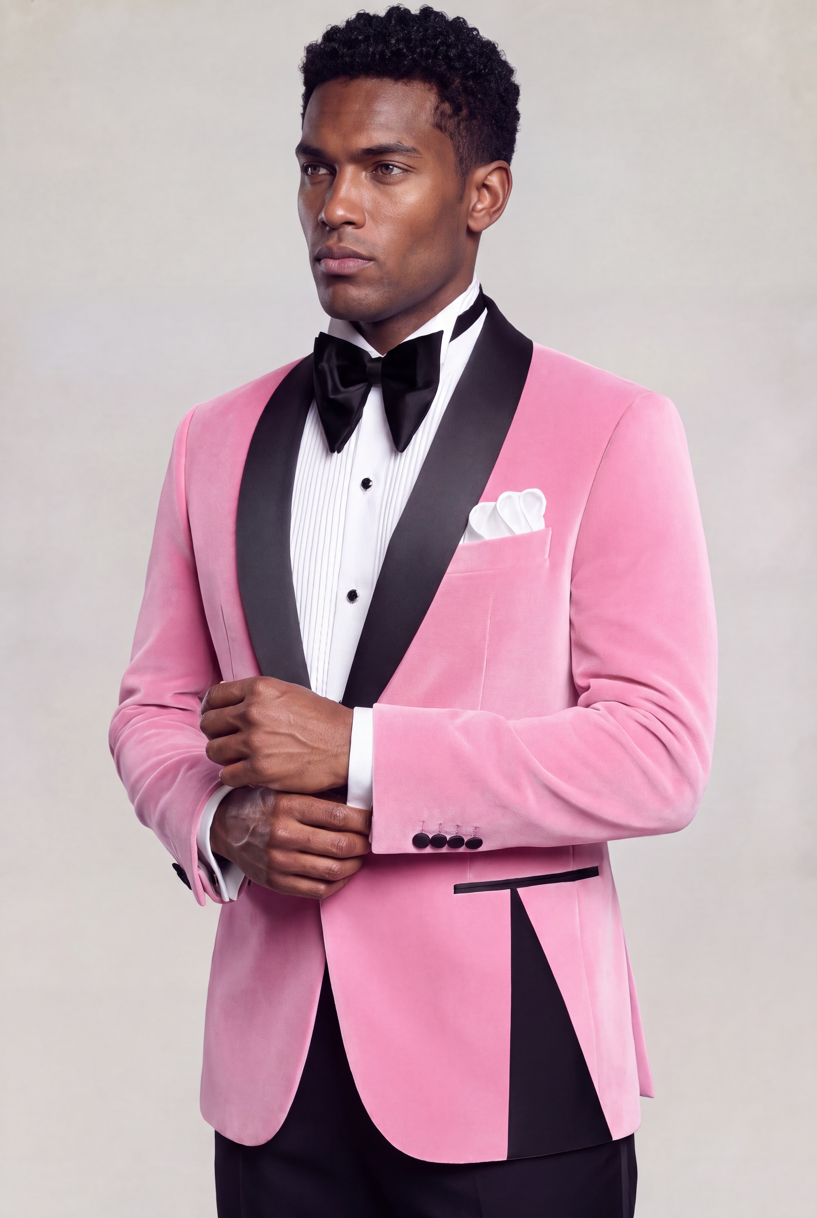 Men's light pink velvet tuxedo jacket, side view while styling the cuff — Gentleman's Guru
