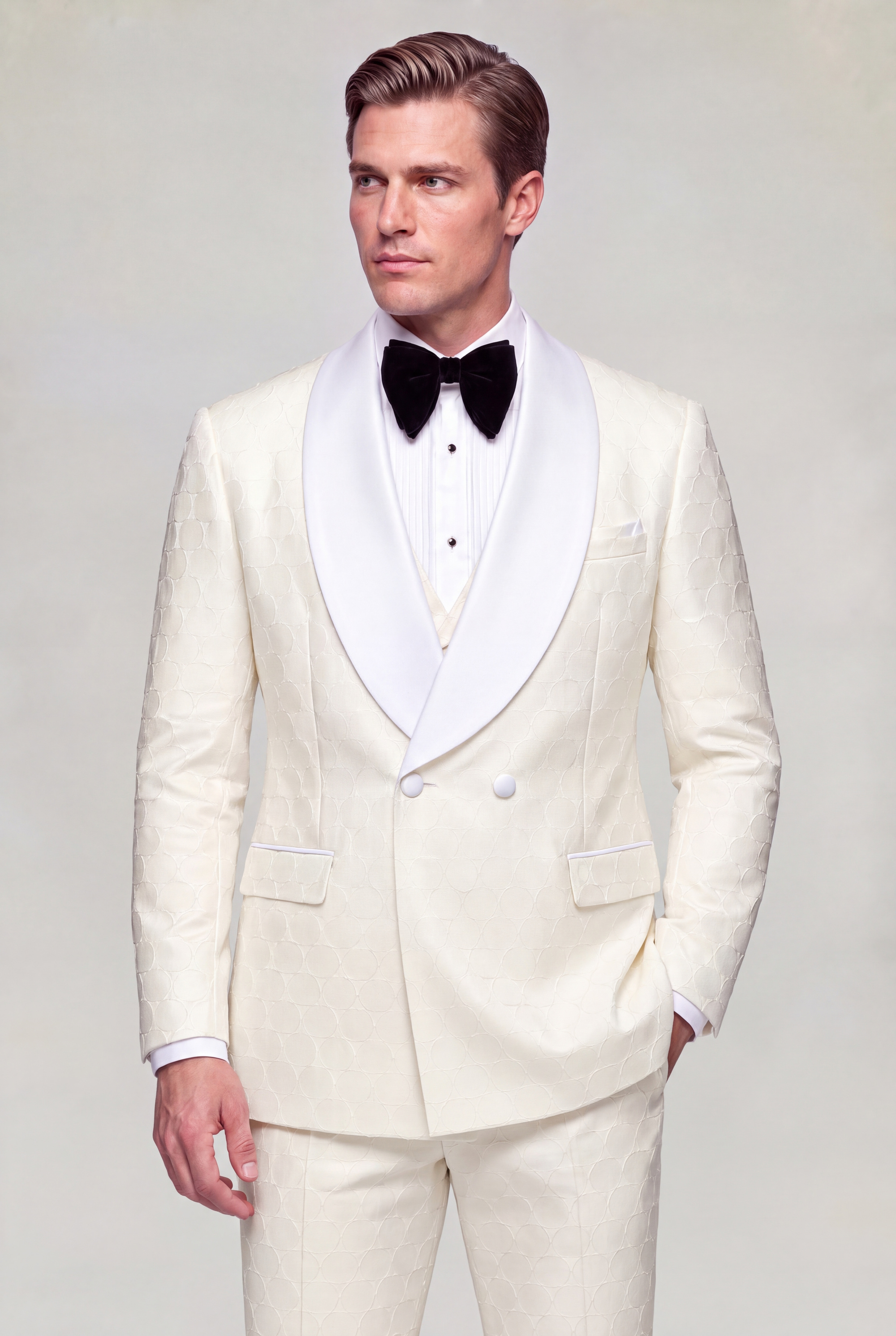Three quarter view of a cream polka dot tuxedo with overlapping double breasted closure and matching trousers from Gentleman’s Guru