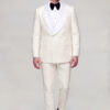 Full length front walking view of a cream three piece tuxedo with matching trousers and black dress shoes from Gentleman’s Guru