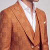 Close-up of burnt orange windowpane peak lapel and white pocket square