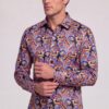 Men’s colorful paisley shirt with model adjusting the cuff