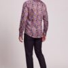 Back and three-quarter view of men’s colorful paisley shirt with black dress pants