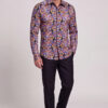 Men’s colorful paisley shirt with black dress pants in a stylish full-body pose