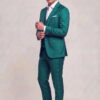 Three-quarter full-body view of a teal green floral three-piece suit while adjusting a shirt cuff