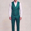 Full-body view of a teal green floral vest and matching trousers worn with an open-collar white shirt
