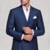 Double-breasted dark blue floral suit in a natural cuff-adjusting pose