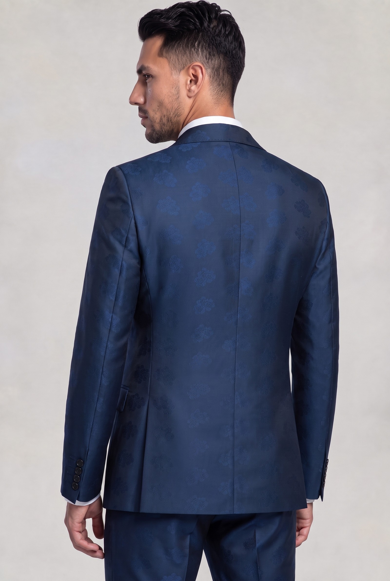Rear view of dark blue floral suit jacket showing pattern and center seam