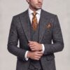 Dark grey plaid suit in a natural cuff-adjusting pose
