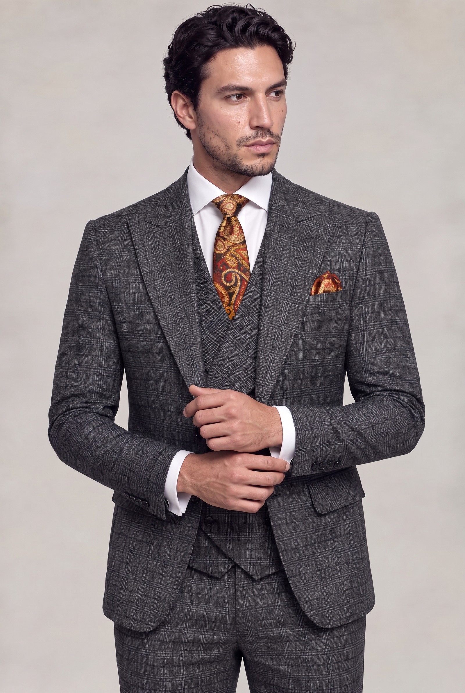 Dark grey plaid suit in a natural cuff-adjusting pose