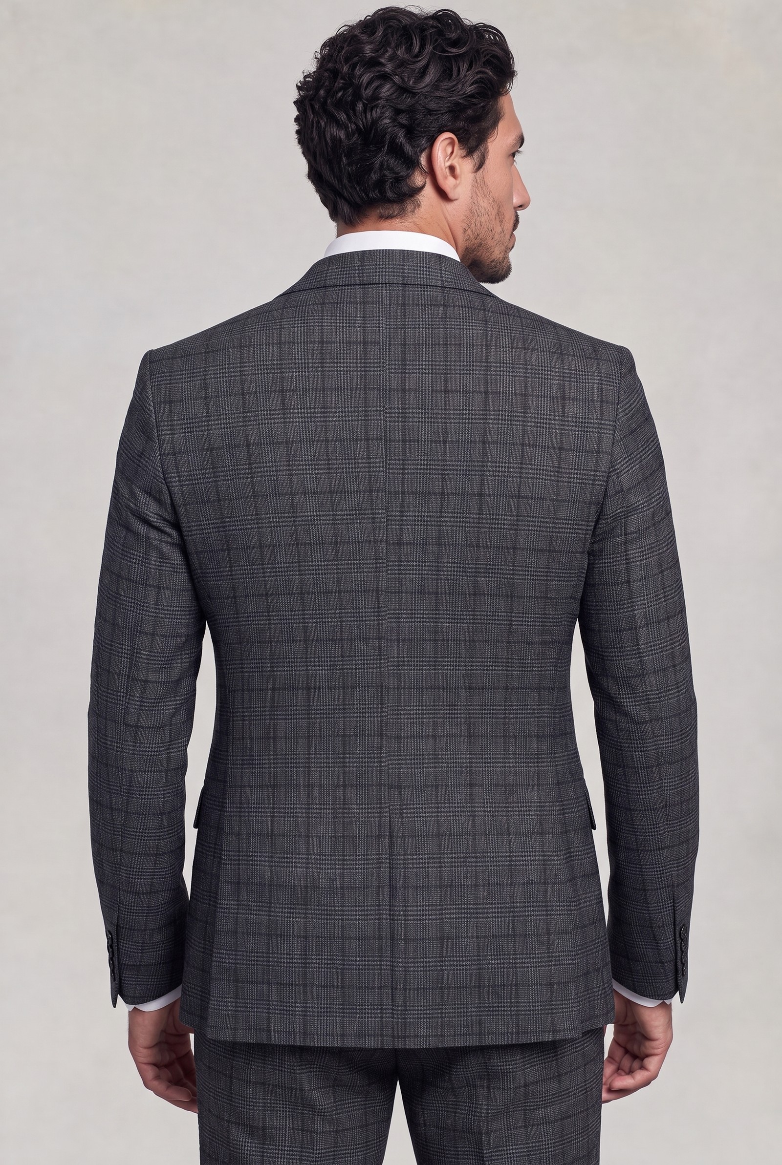 Rear view of dark grey plaid suit jacket showing tailored back and matching trousers