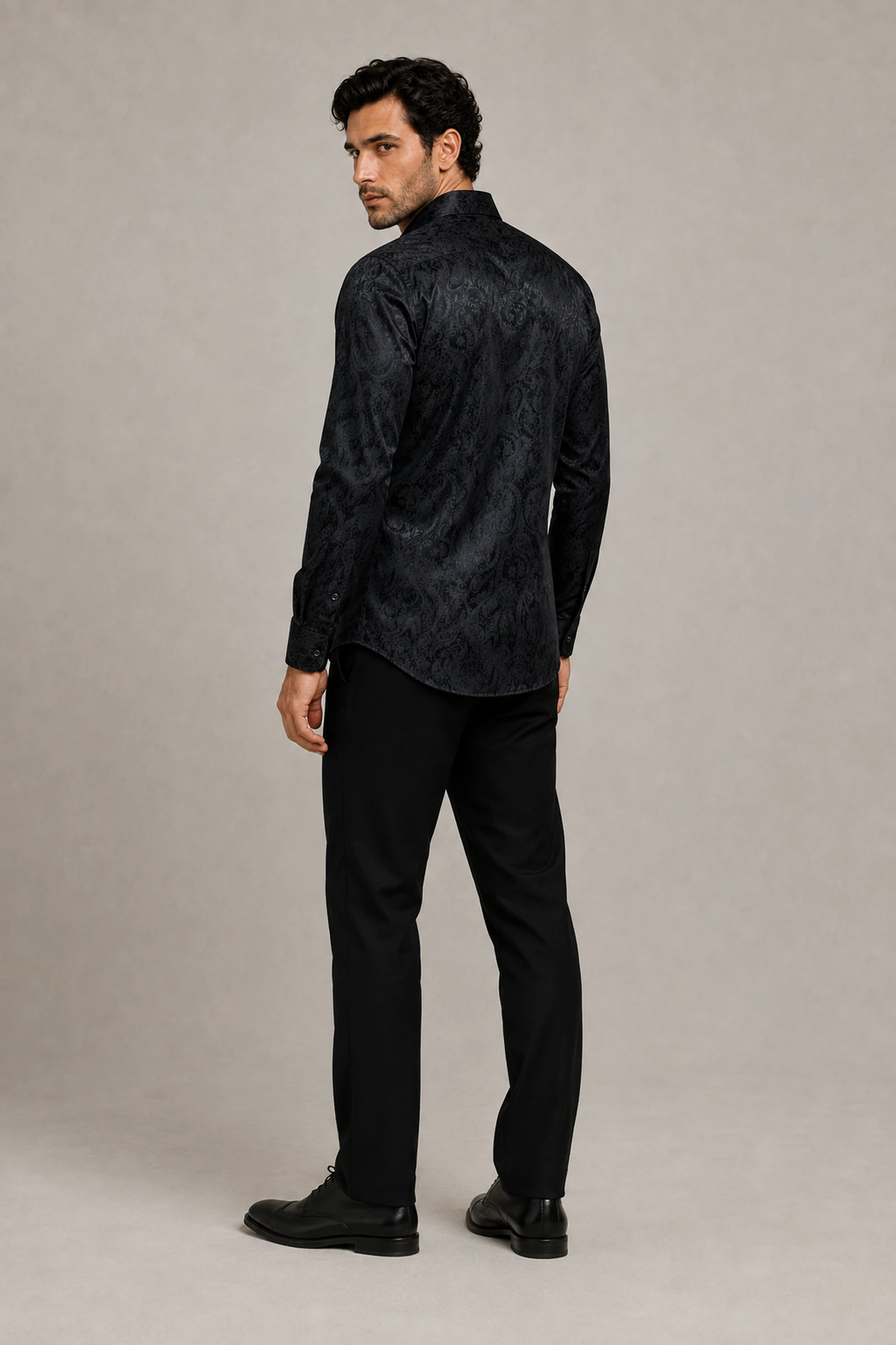 Men's black paisley wedding guest shirt shown full length from the back from Gentleman's Guru